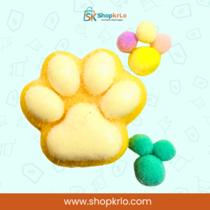Yellow cat paw squishy toy in hand, showing comfortable palm grip