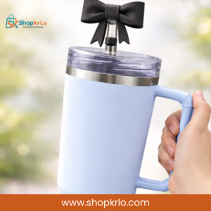 Decorative black bow topper attached to reusable straw on a blue tumbler