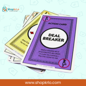 Close-up of Monopoly Deal action cards featuring the powerful Deal Breaker card